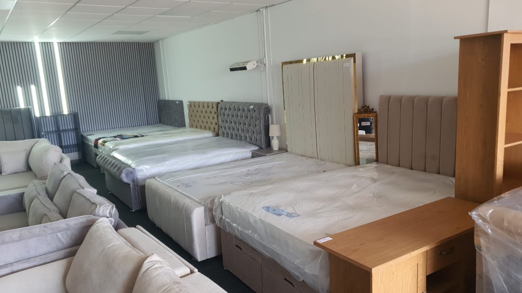 Beds and sofas lined up in the MB Furniture showroom